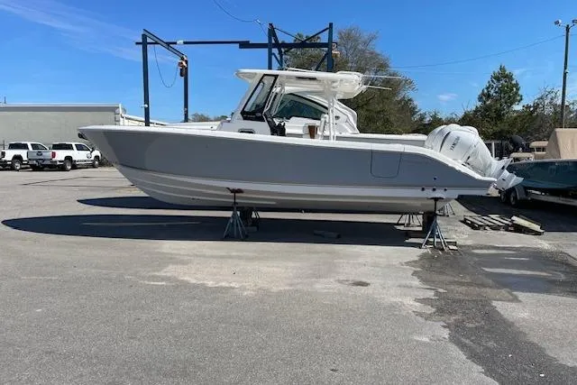 The Image of 2026 Pursuit S 288 Sport boat on stands in a parking lot. - 1