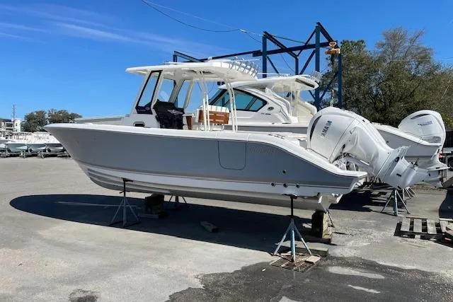 Slide: The Image of 2026 Pursuit S 288 Sport boat on dry dock with twin engines. - 2