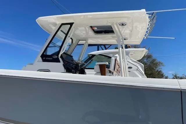 Slide: The Image of 2026 Pursuit S 288 Sport boat with sleek design and modern features under clear blue sky. - 3