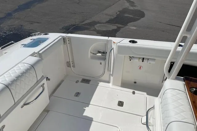 Slide: The Image of 2026 Pursuit S 288 Sport boat interior with white seating and storage compartments. - 6