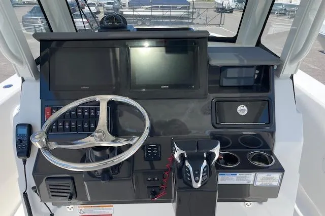 Slide: The Image of Helm of 2026 Pursuit S 288 Sport boat with modern controls and displays. - 8
