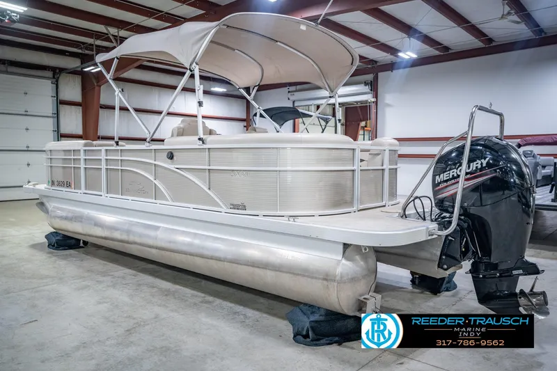 Slide: The Image of 2018 Bennington 23 SSRX pontoon boat with Mercury outboard in a storage facility. - 10