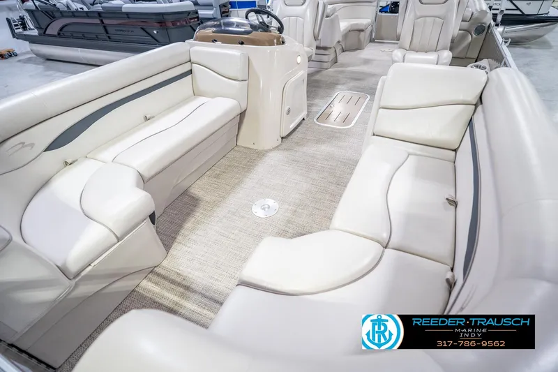 Slide: The Image of 2018 Bennington 23 SSRX pontoon boat interior with beige seating and steering console. - 12