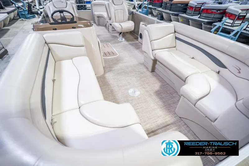 Slide: The Image of 2018 Bennington 23 SSRX pontoon boat interior with beige seating and carpeted floor. - 13