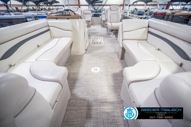 Slide: The Image of 2018 Bennington 23 SSRX pontoon boat interior with beige seating and carpet flooring. - 16