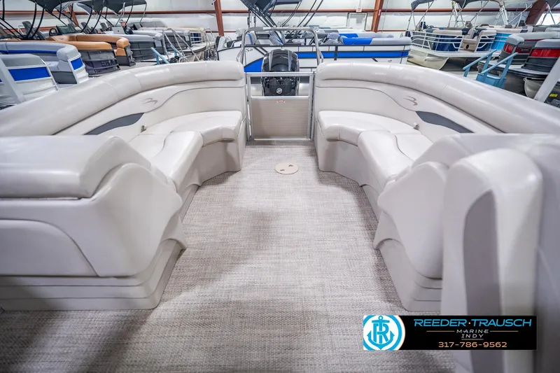 Slide: The Image of 2018 Bennington 23 SSRX pontoon boat interior with plush seating in showroom. - 18