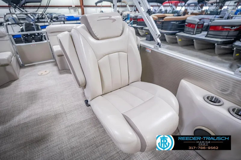 Slide: The Image of 2018 Bennington 23 SSRX boat interior with beige seating and cup holders. - 25