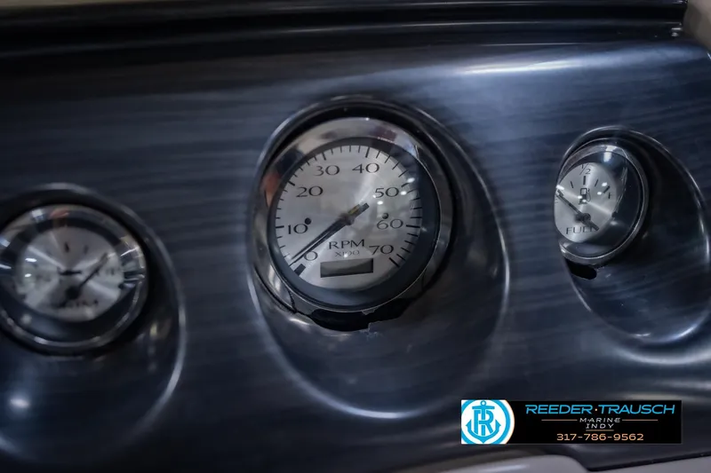 Slide: The Image of Dashboard gauges of a 2018 Bennington 23 SSRX boat, featuring RPM and fuel indicators. - 34