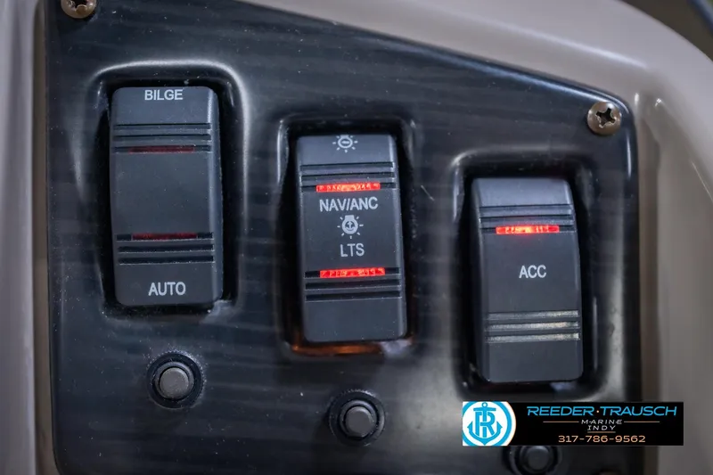 Slide: The Image of Control panel of a 2018 Bennington 23 SSRX boat with labeled switches. - 35