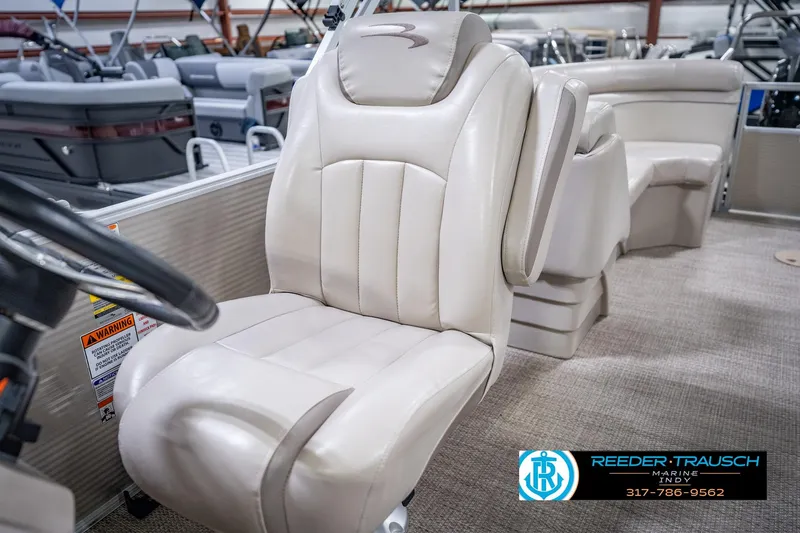 Slide: The Image of 2018 Bennington 23 SSRX boat interior with plush captain's chair and steering wheel. - 38
