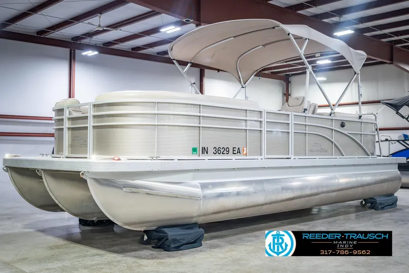 Slide: The Image of 2018 Bennington 23 SSRX pontoon boat in indoor showroom with canopy. - 4