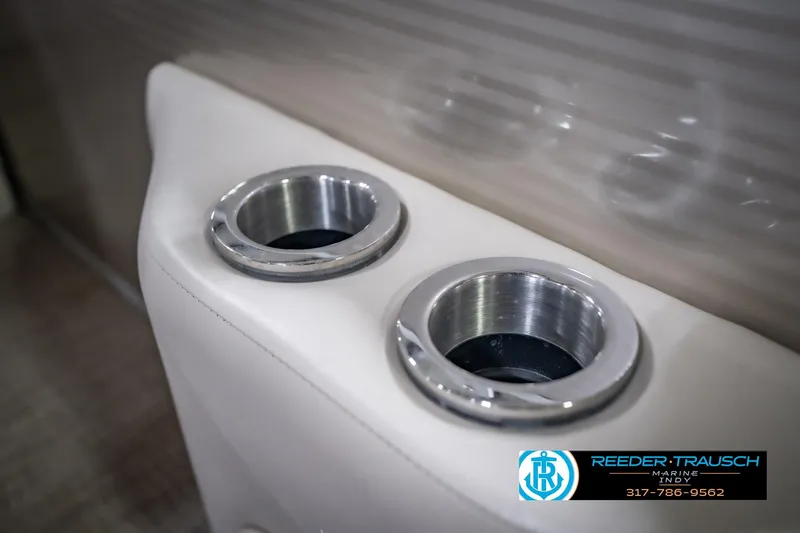 Slide: The Image of Cup holders on a 2018 Bennington 23 SSRX boat, featuring sleek metal rims. - 44