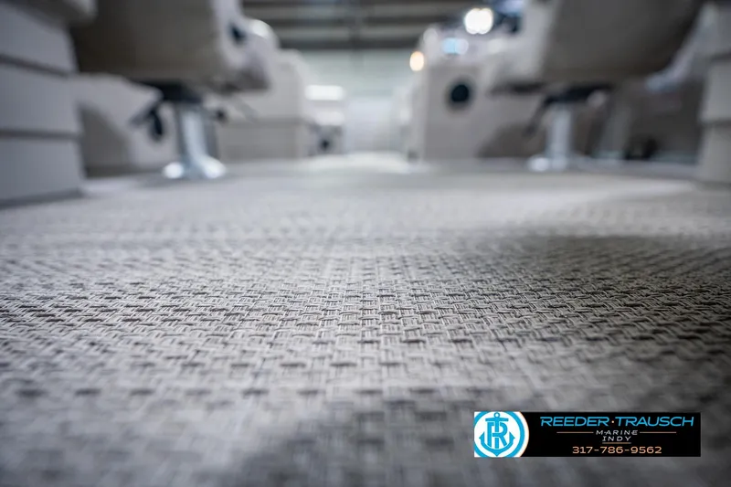 Slide: The Image of Carpeted interior of a 2018 Bennington 23 SSRX boat, showcasing textured flooring. - 46