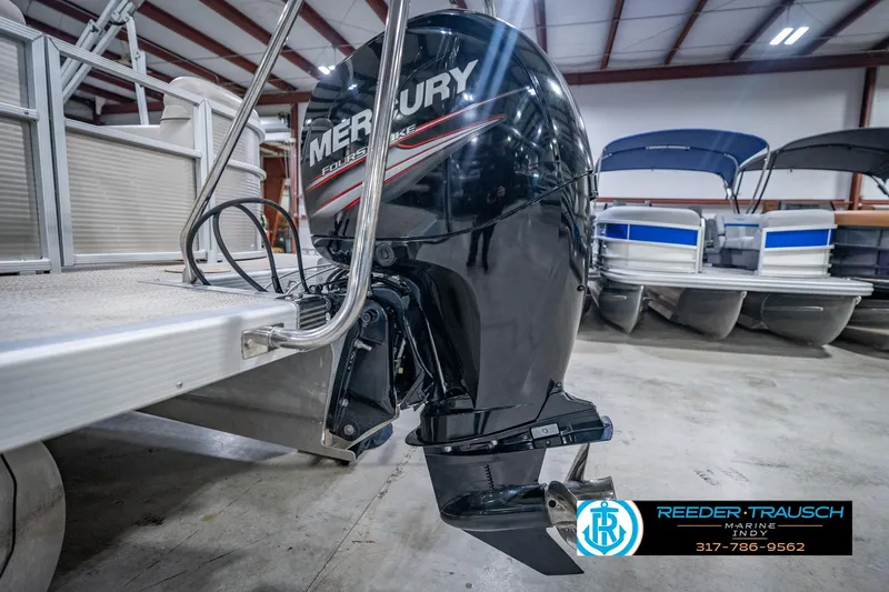 Slide: The Image of 2018 Bennington 23 SSRX pontoon boat with Mercury outboard motor in showroom. - 47