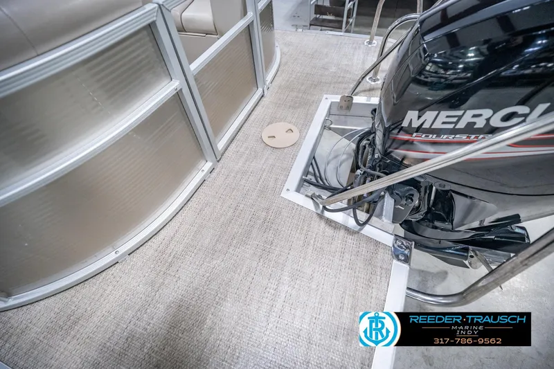 Slide: The Image of 2018 Bennington 23 SSRX boat with Mercury engine, beige interior, and Reeder-Trausch Marine branding. - 54