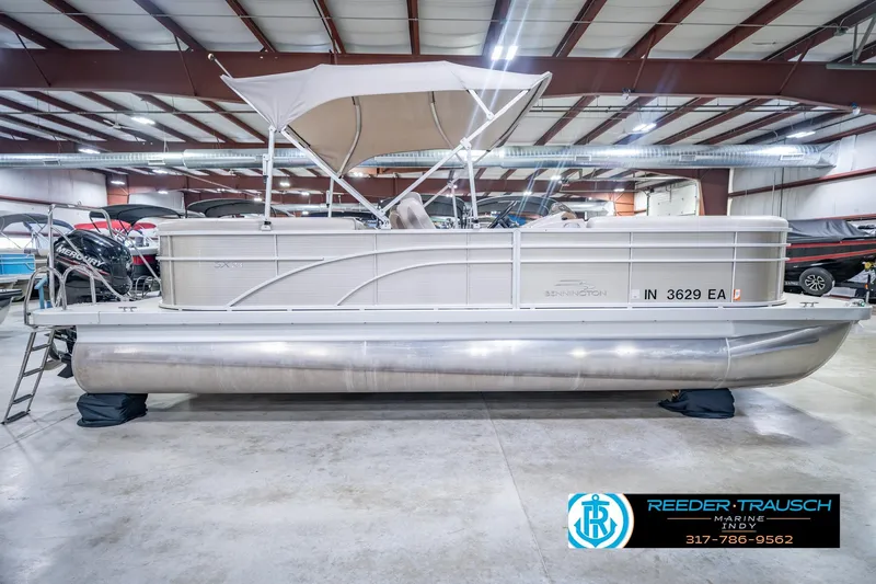 Slide: The Image of 2018 Bennington 23 SSRX pontoon boat in indoor showroom with canopy. - 7