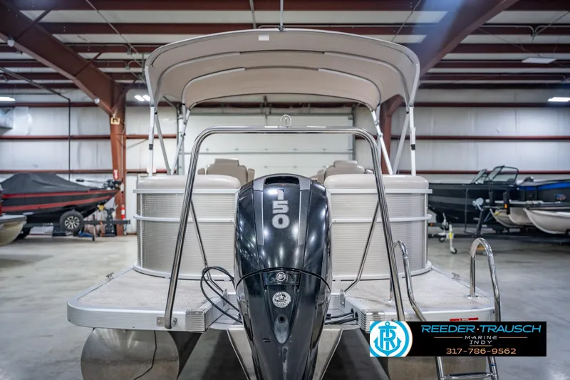Slide: The Image of 2018 Bennington 23 SSRX pontoon boat with 150 HP engine in a showroom. - 9