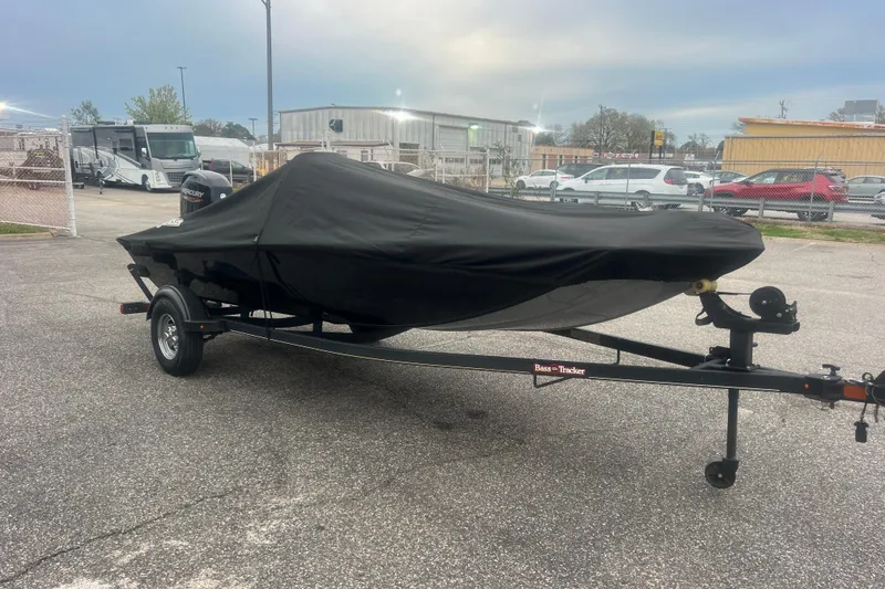 Slide: The Image of 2023 Tracker Bass Tracker Classic XL boat covered on a trailer in a parking lot. - 47