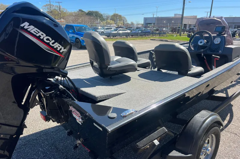 Slide: The Image of 2023 Tracker Bass Tracker Classic XL boat with Mercury engine, parked outdoors. - 58