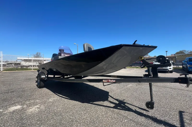 Slide: The Image of 2023 Tracker Bass Tracker Classic XL boat on trailer under clear blue sky. - 62