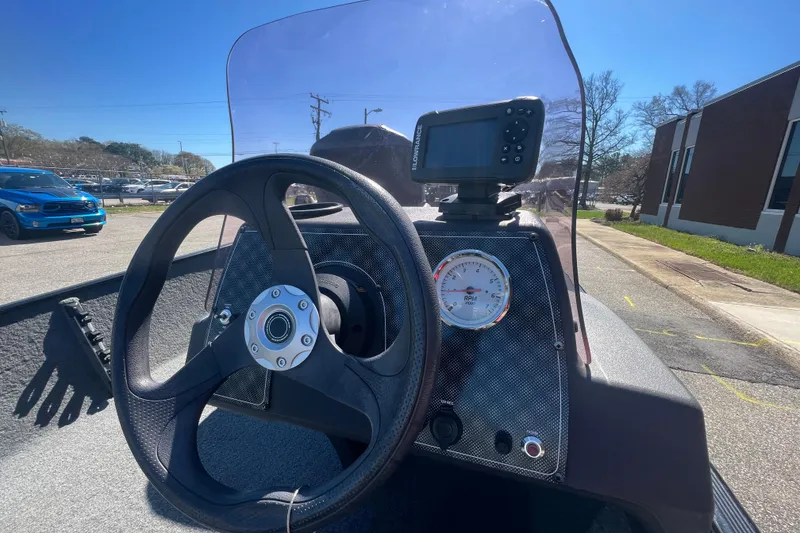 Slide: The Image of 2023 Tracker Bass Tracker Classic XL dashboard with steering wheel and navigation display. - 68