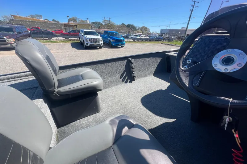 Slide: The Image of 2023 Tracker Bass Tracker Classic XL boat interior with steering wheel and seating. - 69