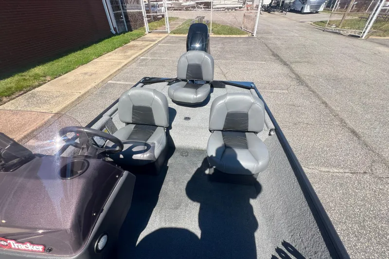 Slide: The Image of 2023 Tracker Bass Tracker Classic XL boat interior with three gray seats. - 75