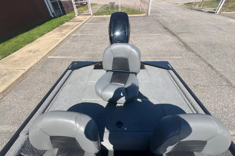 Slide: The Image of 2023 Tracker Bass Tracker Classic XL boat with gray seating in a parking lot. - 76