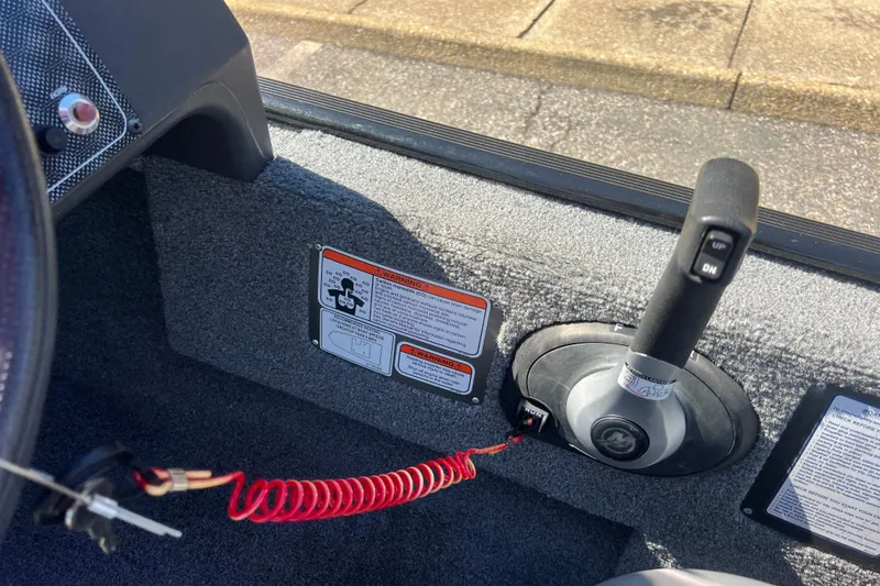 Slide: The Image of 2023 Tracker Bass Tracker Classic XL boat throttle control with safety lanyard and warning labels. - 80