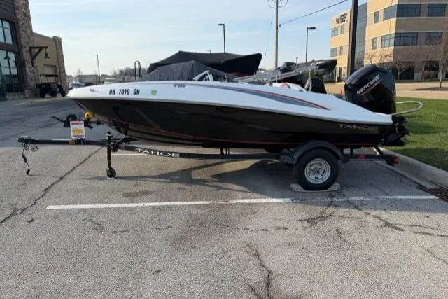 The Image of 2024 Tahoe T16 boat on trailer in parking lot, side view. - 0