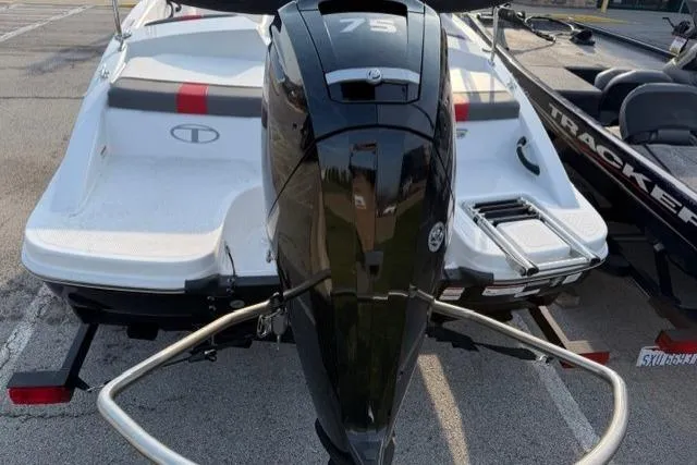 Slide: The Image of 2024 Tahoe T16 boat with 75 HP outboard motor, parked on a trailer. - 4
