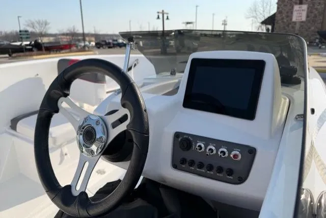 Slide: The Image of 2024 Tahoe T16 boat dashboard with steering wheel and control panel. - 7