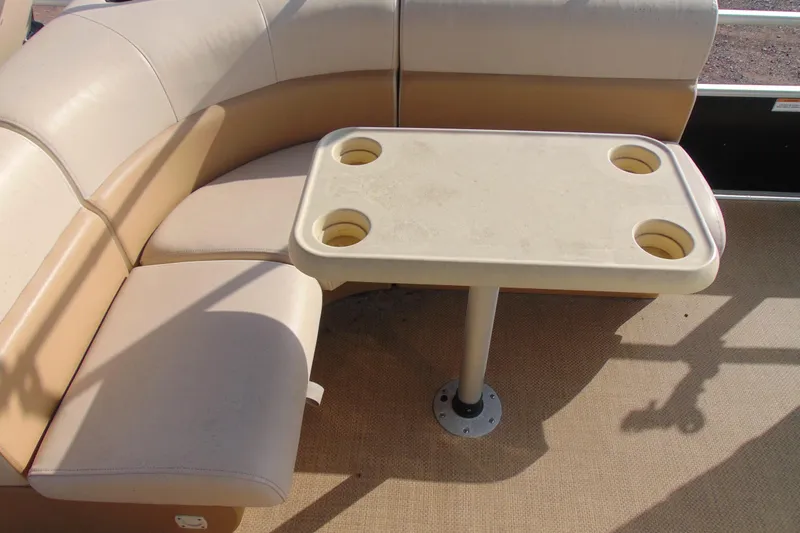 Slide: The Image of 2017 Lexington 317 Pontoon seating area with table and cup holders. - 11