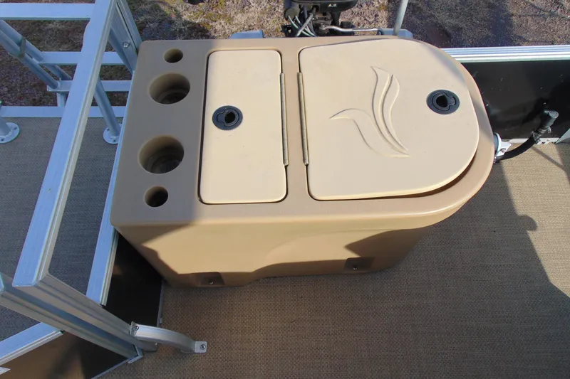Slide: The Image of 2017 Lexington 317 pontoon boat storage compartment with cup holders and embossed logo. - 14