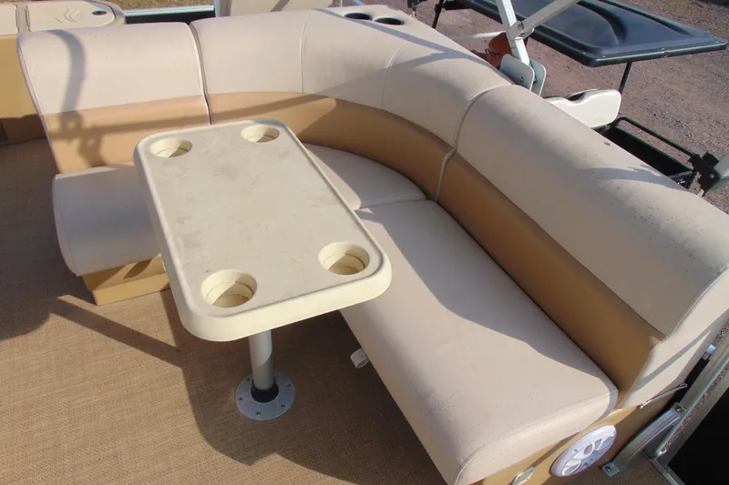 Slide: The Image of 2017 Lexington 317 pontoon seating area with beige upholstery and table with cup holders. - 9