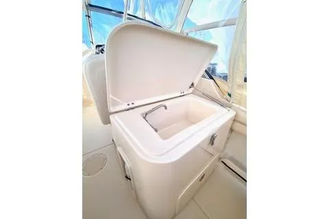 Slide: The Image of 2017 Grady-White Freedom 255 boat interior with open storage compartment. - 10