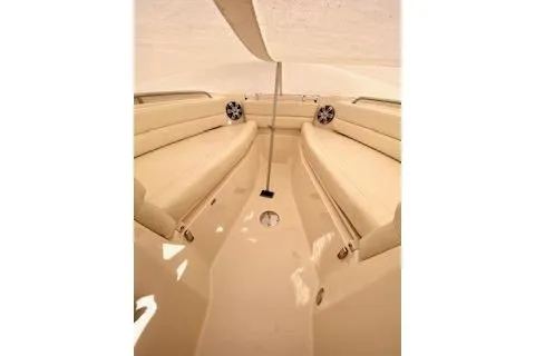 Slide: The Image of 2017 Grady-White Freedom 255 boat interior with beige seating and speakers. - 19