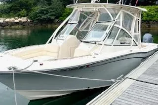 Slide: The Image of 2017 Grady-White Freedom 255 boat docked by the water. - 2