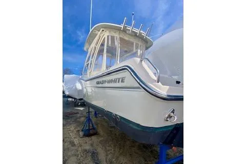 Slide: The Image of 2017 Grady-White Freedom 255 boat on stands, side view under clear blue sky. - 4
