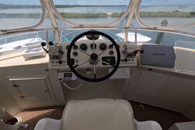 Slide: The Image of 1987 Californian 45 Motor Yacht helm with steering wheel and navigation equipment. - 10