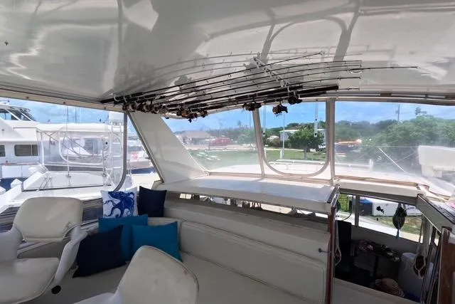 Slide: The Image of 1987 Californian 45 Motor Yacht interior with fishing rods and seating area. - 11