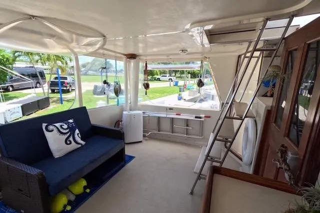 Slide: The Image of 1987 Californian 45 Motor Yacht interior with seating, ladder, and outdoor view. - 14