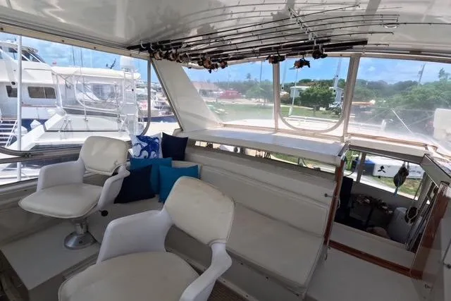 Slide: The Image of 1987 Californian 45 Motor Yacht interior with seating and fishing rods. - 15