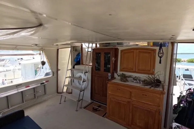 Slide: The Image of Interior of 1987 Californian 45 Motor Yacht with wooden cabinetry and ladder access. - 17
