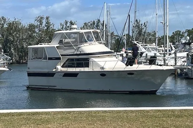 Slide: The Image of 1987 Californian 45 Motor Yacht docked in a marina with clear skies. - 2