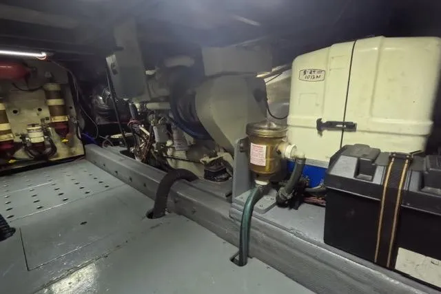 Slide: The Image of Engine room of a 1987 Californian 45 Motor Yacht, showcasing mechanical components. - 25