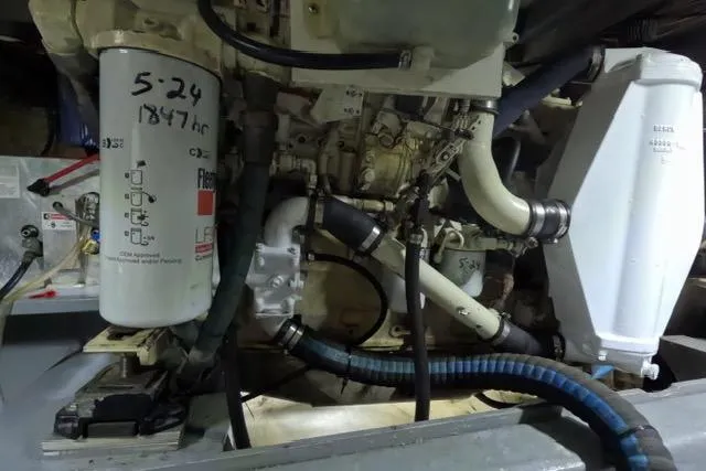 Slide: The Image of Engine compartment of a 1987 Californian 45 Motor Yacht, showcasing filters and hoses. - 30