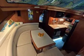 Slide: The Image of 1987 Californian 45 Motor Yacht interior with cozy dining area and compact kitchen. - 39