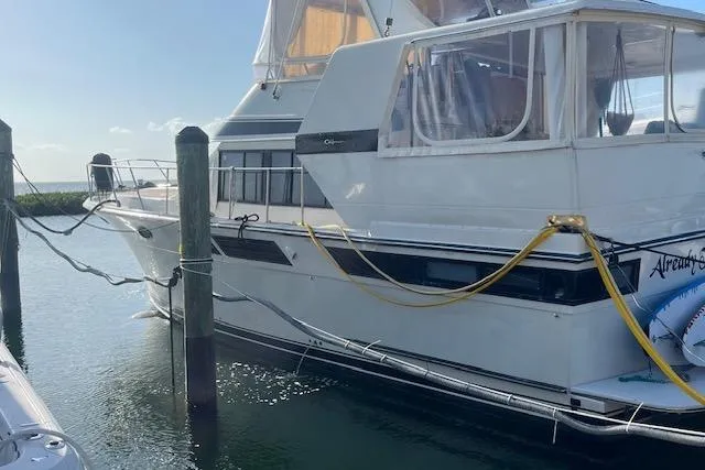 Slide: The Image of 1987 Californian 45 Motor Yacht docked, featuring classic design and spacious cabin. - 4