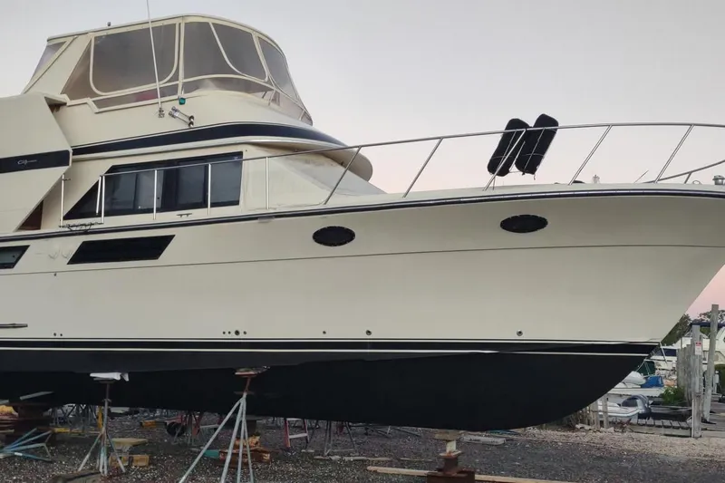 Slide: The Image of 1987 Californian 45 Motor Yacht on stands, showcasing sleek design and spacious cabin. - 5